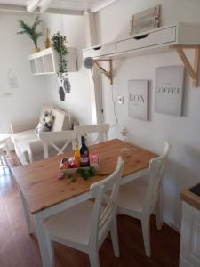 a dining room with a wooden table and white chairs at Cozy Apartments Portorož in Portorož