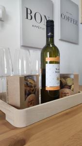 a bottle of wine sitting on a table with wine glasses at Cozy Apartments Portorož in Portorož
