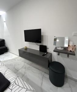 a living room with a tv on a white wall at MA-LU apartment Osijek in Osijek +6 photos