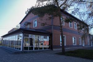 a store front of a red building with windows at Гостевой дом Северный Дворик in Kostanay