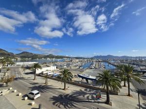 a view of a harbor with palm trees and a marina at Apartamento Joandani by Feseal - Puerto Pollensa in Port de Pollensa