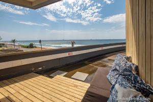 a balcony with a view of the beach and the ocean at High Tide at Umdloti Resort in Umdloti