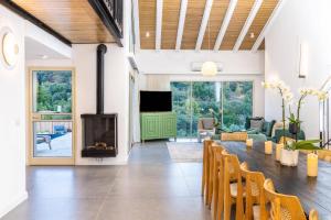 a living room with a fireplace and a table and chairs at רום אמירים - מתחם אירוח מהמם עם בריכות מחוממות מול נוף עוצר נשימה in Amirim