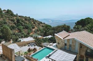 an aerial view of a house with a swimming pool at רום אמירים - מתחם אירוח מהמם עם בריכות מחוממות מול נוף עוצר נשימה in Amirim