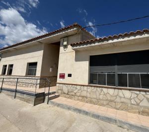 a building with a bench in front of it at Albergue El Muro in Monforte de Moyuela