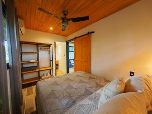 a bedroom with a bed and a ceiling fan at Casas del bosque Nosara in Nosara