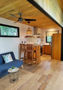 a living room and kitchen with a couch and a table at Casas del bosque Nosara in Nosara