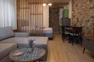 a living room with a couch and a table at The Lake House Angeliki in Kanália
