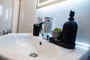 a bathroom sink with a soap dispenser on it at Manchester - 4 Beds - Sleeps 7 - Street Parking in Manchester