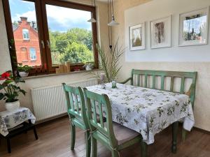 a dining room with a table and chairs and a window at FeWo Burgblick in Bad Blankenburg