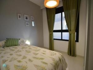 a bedroom with a bed and a window at Ground floor apartment in Pilar de la Horadada - Mil Palmeras Beach in Pilar de la Horadada +14 photos