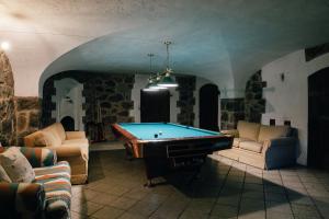 a living room with a pool table in a room at Peetri mõis & spa in Turva