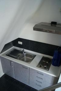 una cocina con fregadero y estufa en Ostsee, en Diedrichshagen