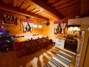 a kitchen with a christmas tree in a room at Chata Devena in Stará Turá