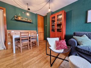 a living room with a couch and a dining room at Hauzify I Domus Molina in La Molina