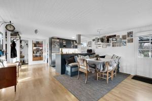 a kitchen and dining room with a table and chairs at Lovely House In Scenic Thy in Thyholm
