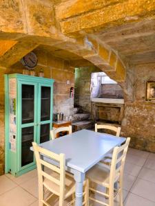 a kitchen with a table and chairs in a room at The Valletta G-House in Valletta