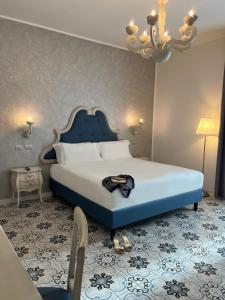 A bed or beds in a room at PLAZA Boutique Hotel - Tropea