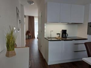 フリンブルクにあるApartment Waterside Heavenの白いキャビネットとカウンタートップを備えたキッチン +26枚の写真