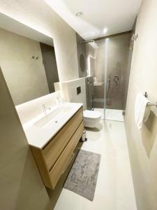 a bathroom with a sink and a toilet at Apartamento LaViu 2B by Croma in Estepona