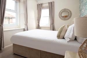 een bed in een kamer met een raam bij Hexham Cottage by Coast & Country Stays in Seahouses +37 foto's