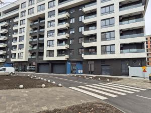 an empty street in front of a large building at Sajam 2 in Novi Sad