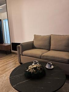 a living room with a couch and a coffee table at Mokoš apartman, Residence hill A35, minimum dve noći in Kopaonik