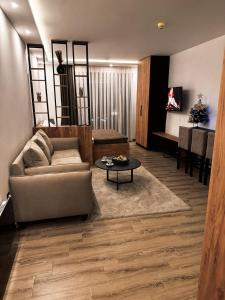 a living room with a couch and a table at Mokoš apartman, Residence hill A35, minimum dve noći in Kopaonik