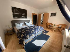 a bedroom with a bed with a blue comforter at Fewo by Seeblick Ferien Edersee, Am See, Haustiere auf Anfrage in Waldeck