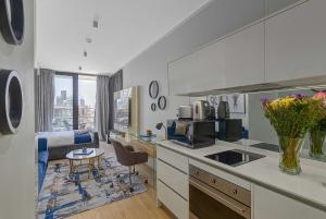 a kitchen with a counter and a living room at Bhonsane Executive Suite, Ellipse, Midrand in Midrand