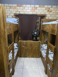 a room with three bunk beds with a cat sitting on top at Hostel Paraíso Embaú in Guarda do Embaú +42 photos
