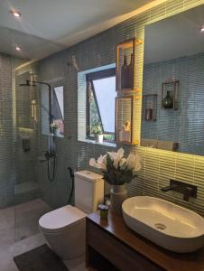 a bathroom with a toilet and a sink at The Green Door in Ella +13 photos