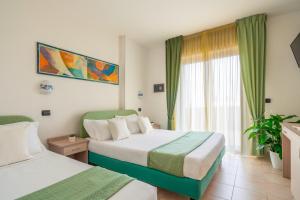 Postel nebo postele na pokoji v ubytování Park Hotel & Dependance con Spiaggia