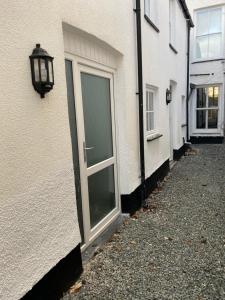 a door on the side of a building with a street at Aberystwyth maisonette flat in Aberystwyth