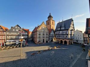 a group of buildings in a town with a clock tower at Marktplatz Ferienwohnung in Alsfeld