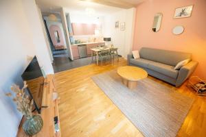 a living room with a couch and a table at Rosalie - Bienvenue dans le cœur historique de Troyes in Troyes