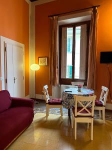 a living room with a couch and a table and chairs at Tosca in Florence