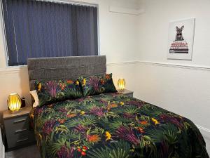 a bedroom with a bed with a colorful bedspread at Levy Nook House 1 bed apartment 5 minute walk to Stockton town centre & Free Parking in Stockton-on-Tees