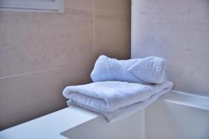 a white towel sitting on the edge of a bath tub at Le Boulingrin in Reims +93 photos