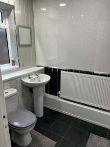 a bathroom with a toilet and a sink at Levy Nook House 1 bed apartment 5 minute walk to Stockton town centre & Free Parking in Stockton-on-Tees +19 photos