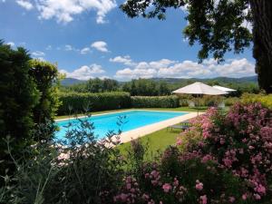 a pool in the garden of a house with flowers at Tenuta San Jacopo - Agriturismo in Cavriglia +81 photos