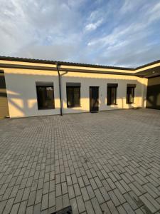 a large white building with a lot of windows at Balon Centrum penzion in Plav