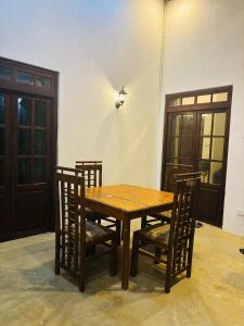 a wooden table with two chairs and a wooden table and a table and chairsktop at Gastfamilie Ella in Ella
