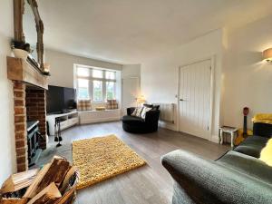 a living room with a couch and a fireplace at 3 Bedrooms - 2 Bath Rooms - Dog Friendly - Parking in Berwick-Upon-Tweed