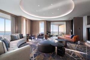a living room with a couch and a table at Sheraton Jeddah Hotel in Jeddah +70 photos