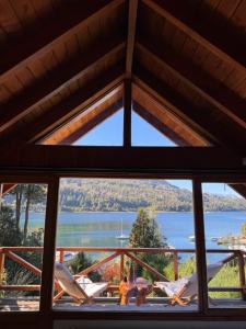 a view of the water from a window in a cabin at El Remanso del Lago in Villa La Angostura