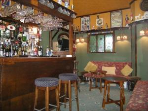 a bar with stools and a counter in a restaurant at Headlands Hotel in Llandudno