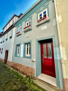 a blue and red building with a red door at Altes Dichterhaus von 1859 in Miltenberg