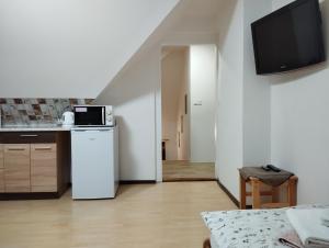 a living room with a kitchen and a microwave at Ubytovani u Nadii in Železný Brod
