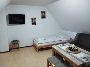 a living room with a couch and a table at Ubytovani u Nadii in Železný Brod